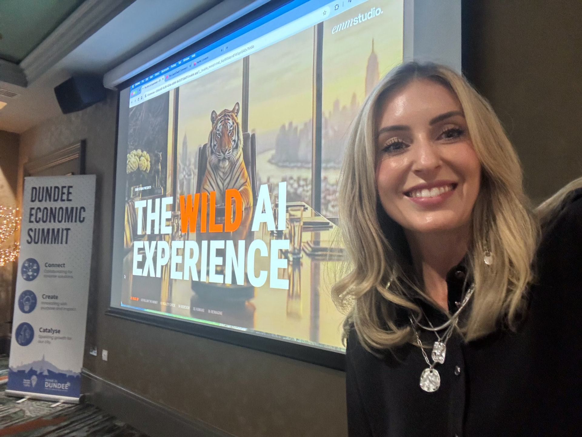 Emily Walters speaking beside a screen showing EMM Studio’s The Wild AI Experience presentation.